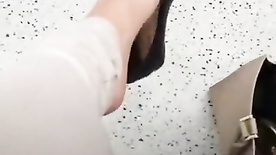 British girl dangling with black flats in subway